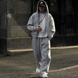 Mann läuft auf einer Straße mit weißen Sneakern 